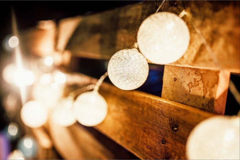 Six of Top Tips to Make Your Backyard and Patio Useable All Year Round: Light Bulb Hanging on A wooden wall