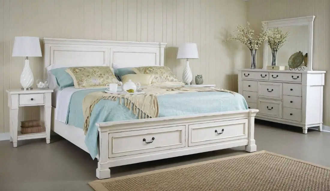 simple classic bedroom with white classic bed, white classic drawers, white lamp, and printed linen with lots of blue colored accents