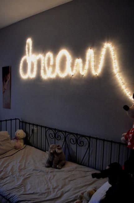 A writing on a wall with LED string lights #ropeLights #lighting #lights #ledLights #stringLights #homeDecor #interiorDesign